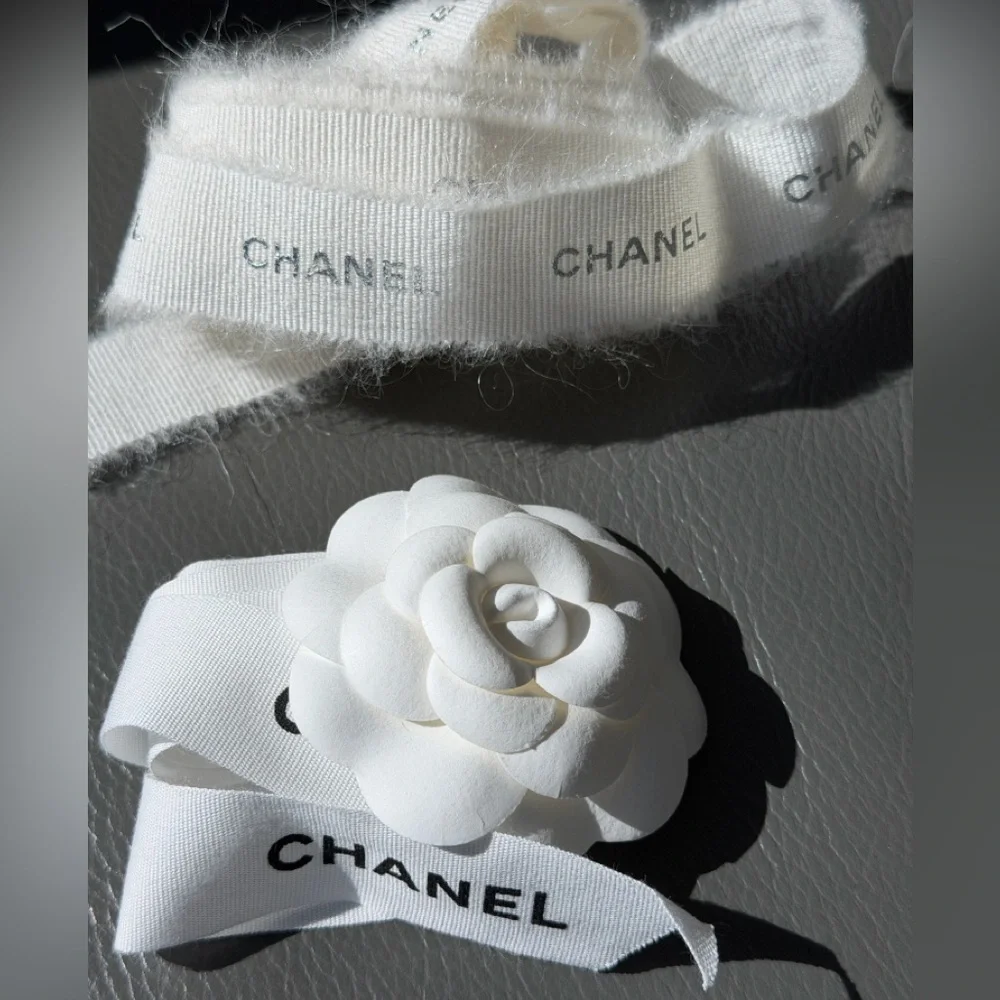 CHANEL 1 CAMELIA FLOWER AND Silver Chanel printed RIBBON,  plus Chanel card.